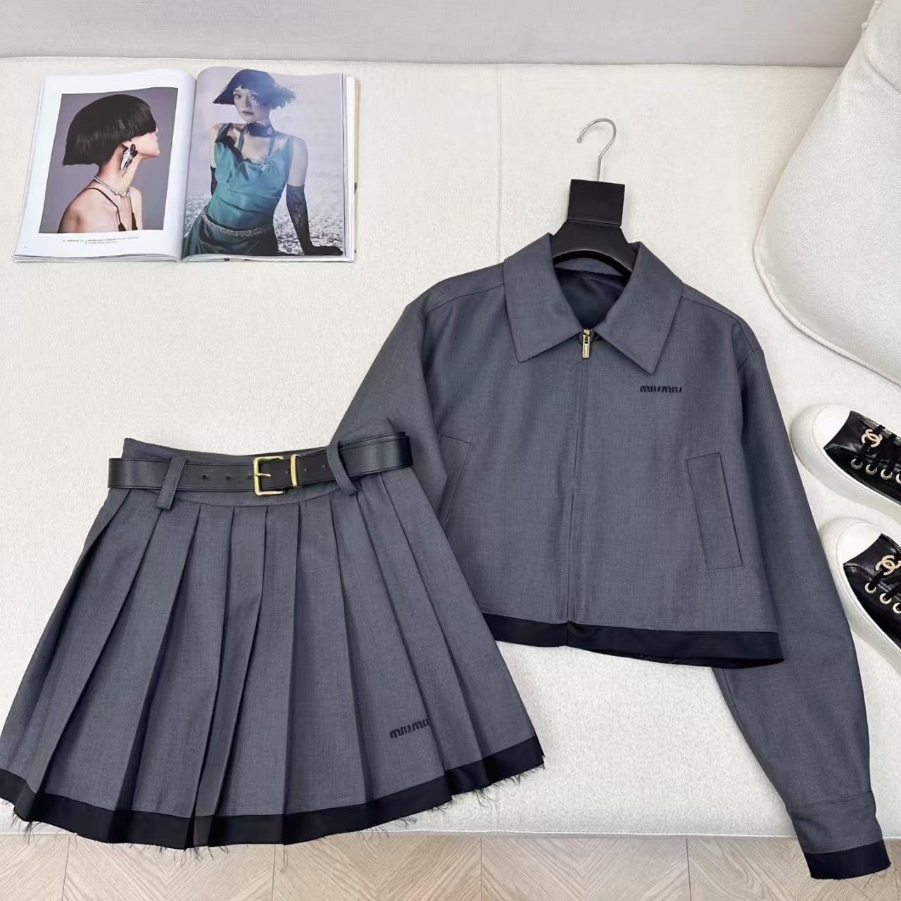 Spliced lapel jacket and belted pleated skirt suit